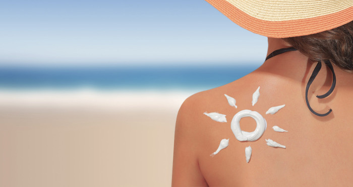 Woman with sun shaped sunscreen on her back
