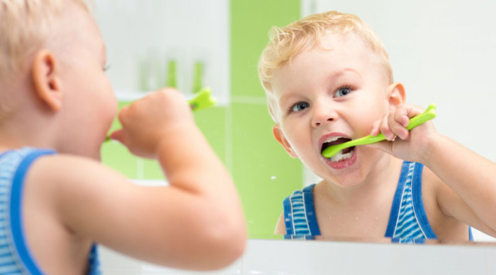 kid boy brushing teeth